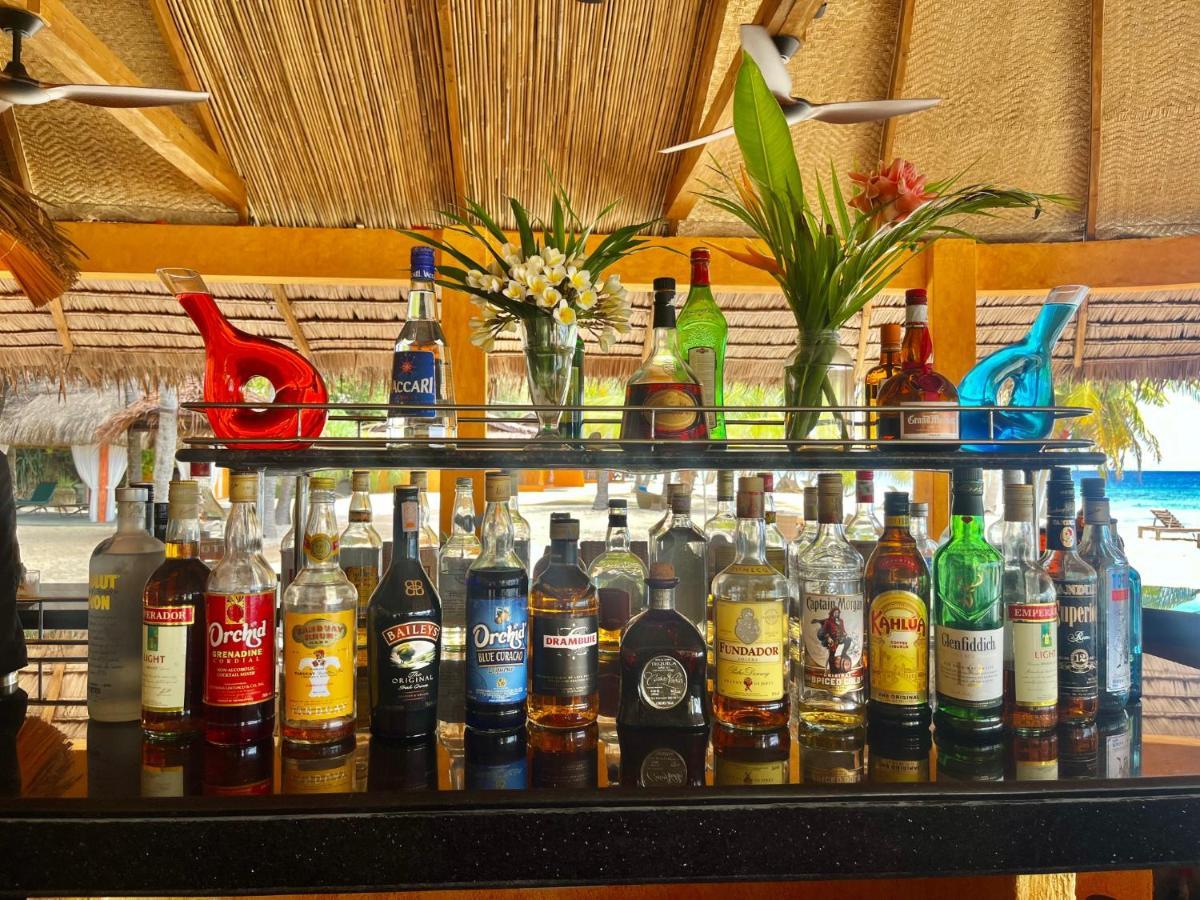 Coco Grove Beach Resort, Siquijor Island Екстер'єр фото Rum bottles at a bar in the Caribbean